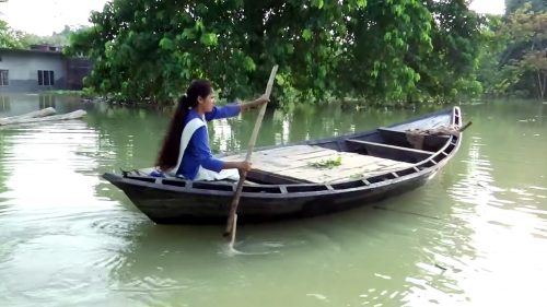 A class 11 student Sandhya Sahani rows a boat daily to reach her school in a flooded area