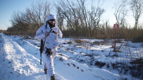 A service member of the Ukrainian armed forces walks at combat positions in Donetsk region