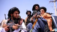 Taliban forces patrol in front of Hamid Karzai International Airport in Kabul